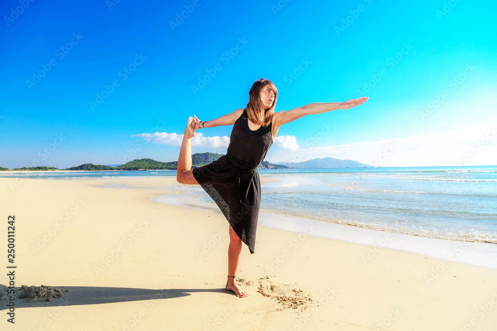 yoga on the beach, young girl in black, early morning, fog