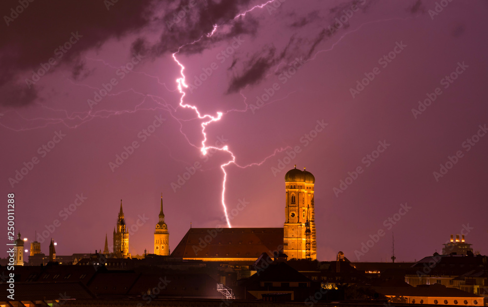 Fototapeta premium lightning strikes into munich cathedral Frauenkirche while thunderstorm. travel bavaria germany skyline München