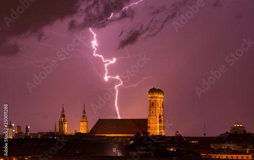 lightning strikes into munich cathedral Frauenkirche while thunderstorm. travel bavaria germany skyline München