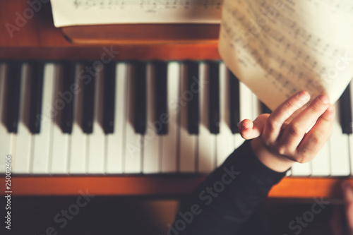 girl hand music book with  piano