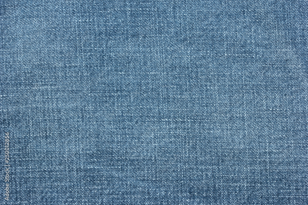 Old blue denim jeans texture or background with visible fibers Old blue denim jeans texture or background with visible fibers