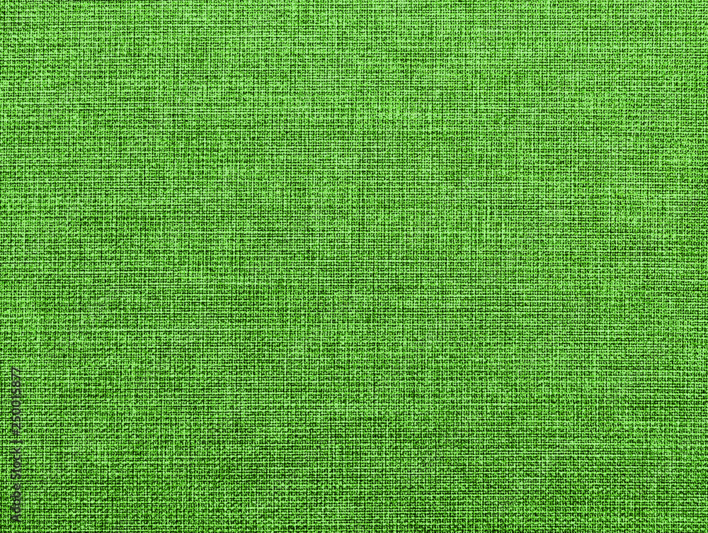 Fototapeta premium The textured green natural fabric. 