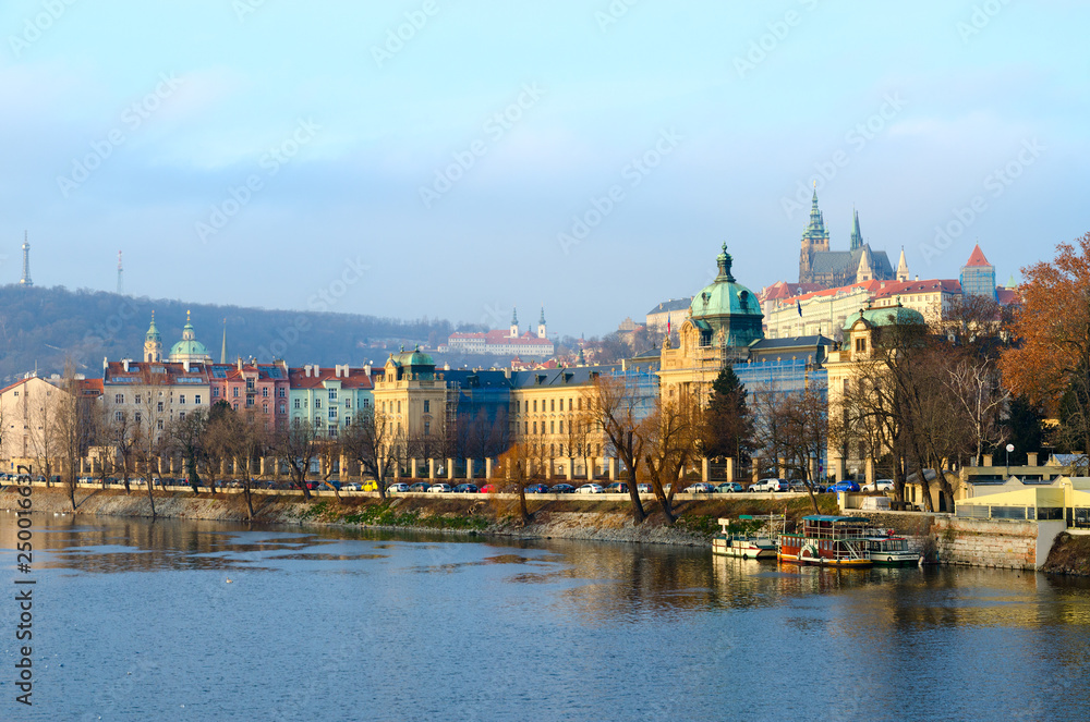 Beautiful morning view of embankment of Vltava River, Strakow Academy (Government House of Czech Republic), Prague Castle
