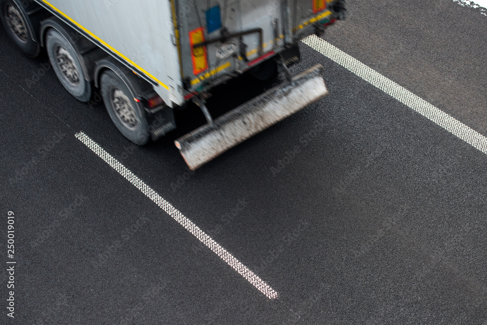 Close-up truck transporting goods by road in winter during the day Close-up truck transporting goods by road in winter during the day