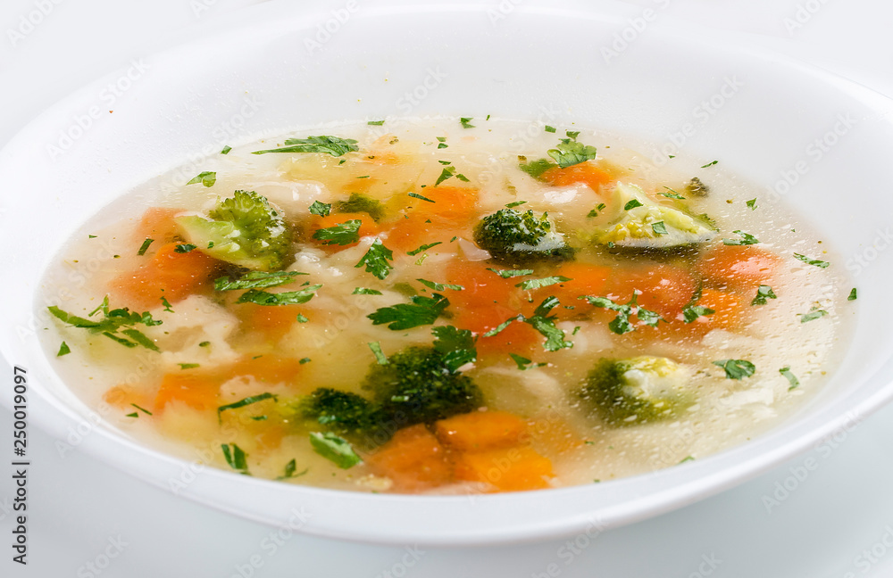 Vegetable soup with broccoli on white background Vegetable soup with broccoli on white background