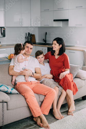 Happy family sitting on couch at home