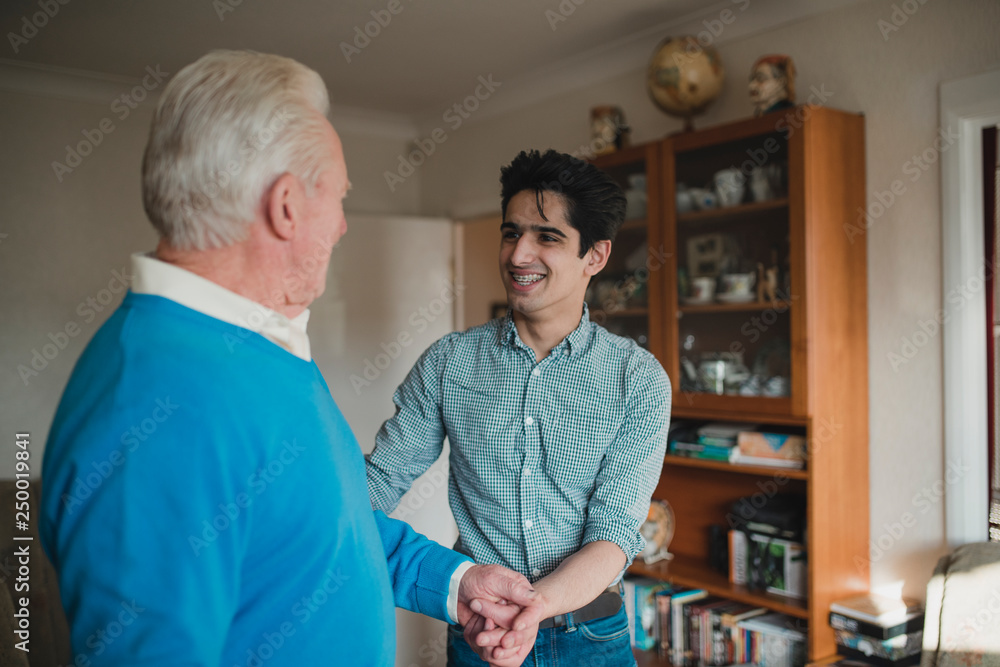 Fototapeta premium Teenager Helping his Grandfather at Home