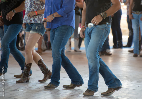 Men and woman line dance in country club photo