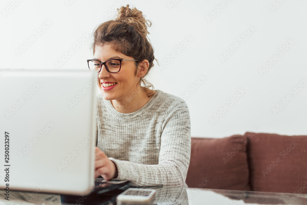 Young woman working at her home. She working at lap top Young woman working at her home. She working at lap top