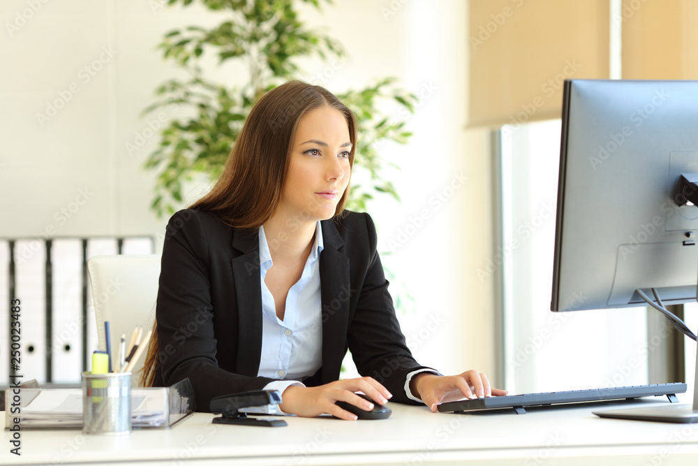 Serious office worker works using computer Serious office worker works using computer