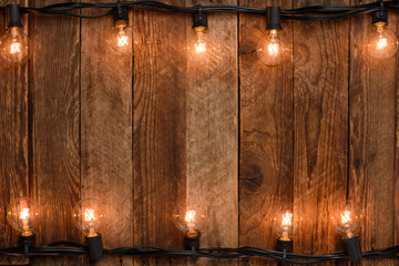 Vintage garland on old rustic wooden wall background