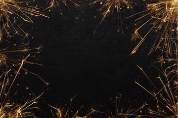 Festive burning sparklers with sparks background. Burning bengal fire with glitter particles frame. Party invitation poster template.