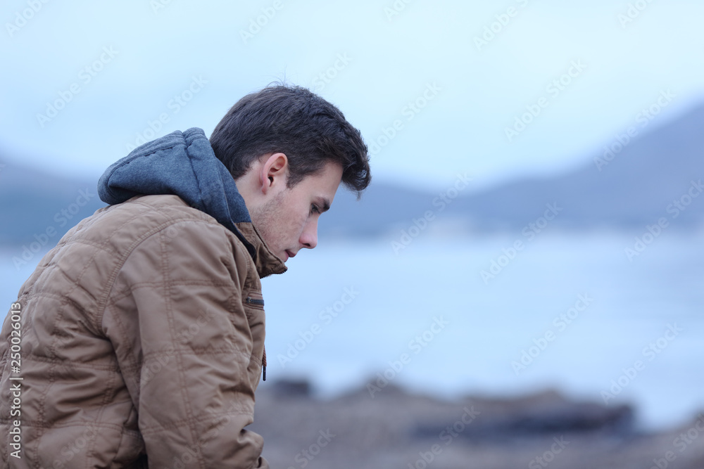 Sad man in winter on the beach complaining Sad man in winter on the beach complaining