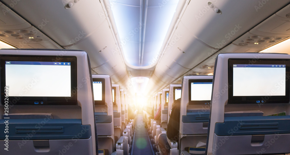 Φωτογραφία Comfortable seats in cabin of commercial aircraft with screens in chairs back