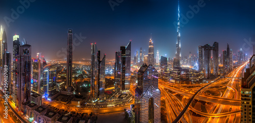 Photography Dubai skyline during sunrise with shining traffic road, United Arab Emirates