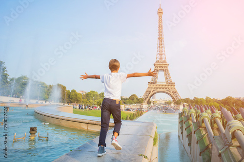 Happy boy walking in centre of Paris. Background of Eiffel tower. Travel concept © Max Topchii