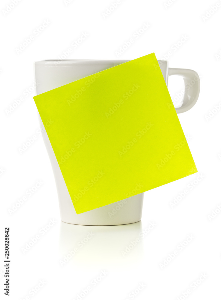 Fotografie Yellow empty sticky note on white coffee or tea cup over white background