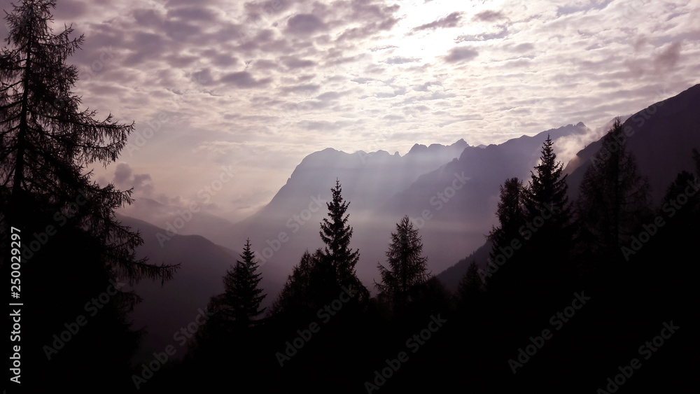 Dolomites, Italy. Hiking from Cortina d'Ampezzo to Lake Sorapis. Evening view of gruppo del Sorapis and Cristallo with beautiful cloudy sky Dolomites, Italy. Hiking from Cortina d'Ampezzo to Lake Sorapis. Evening view of gruppo del Sorapis and Cristallo with beautiful cloudy sky