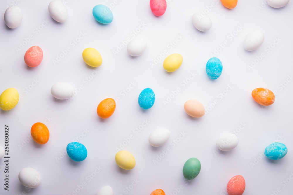 Colored eggs flat lay on a white background. Easter and spring composition. Colored eggs flat lay on a white background. Easter and spring composition.