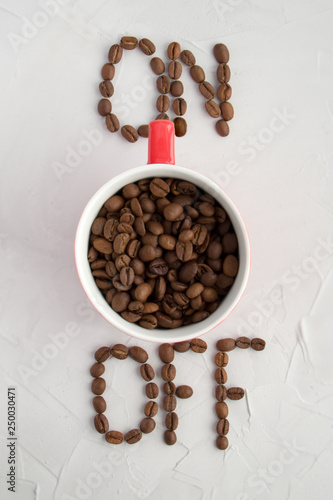 Cup with coffee beans as ON switch on grey background. Creative coffee Cup concept