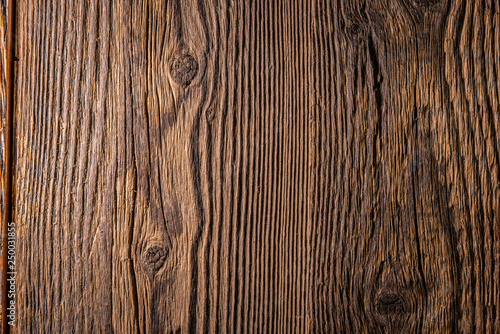 Old dark brown wooden wall, detailed background photo texture. Wood plank fence close up.