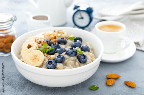 Oatmeal with fresh blueberry, banana, almond nuts and honey for breakfast