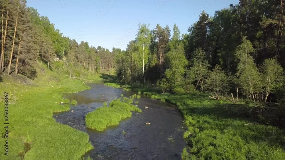 A stormy river flows over a rocky bottom in spring A stormy river flows over a rocky bottom in spring