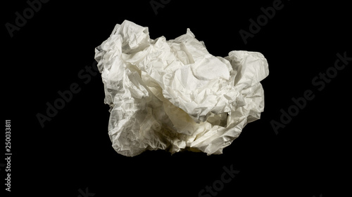 Сrumpled white paper on a black background
