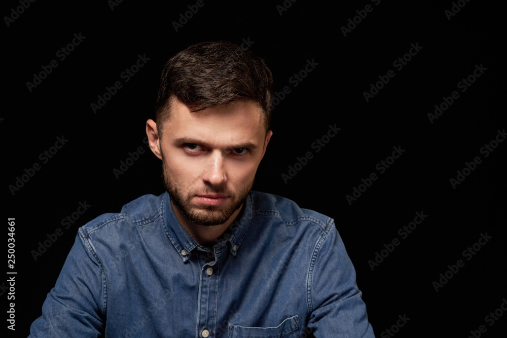 Discontent fowining man looking at camera Discontent fowining man looking at camera