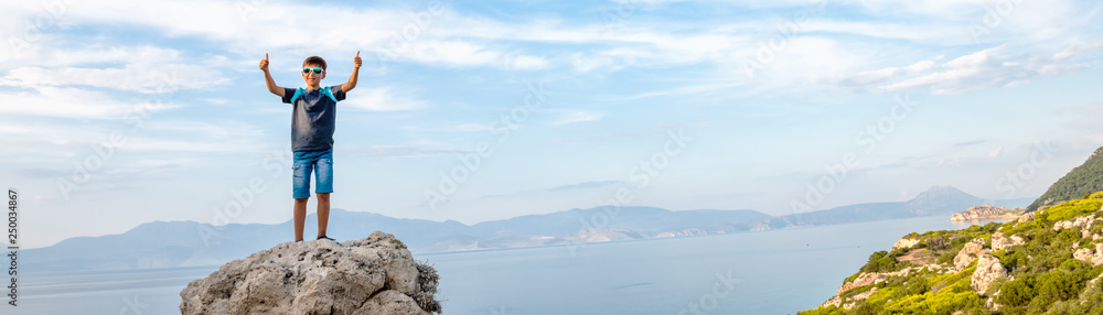 Young boy traveling along the coast of the Mediterranean Sea.