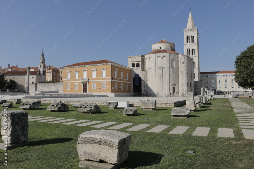Roman Forum and ruins of Roman buildings in Zadar. Tower of the Cathedral of St. Anastasia. Church of St. Donat. Church of St. Maria. Summer, hot, sunny day in Croatia. Dalmatian Riviera, Adriatic Sea