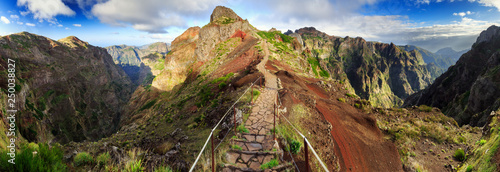 Beautiful 180 degree panoramic landscape panorama of the hiking path in the mountains of Madeira at Pico do Areeiro (Arieiro) while hiking to Pico Ruivo on a cloudy summer day photo