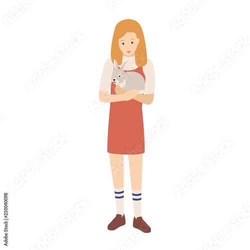 Pretty young woman or girl holding her bunny, rabbit or leveret