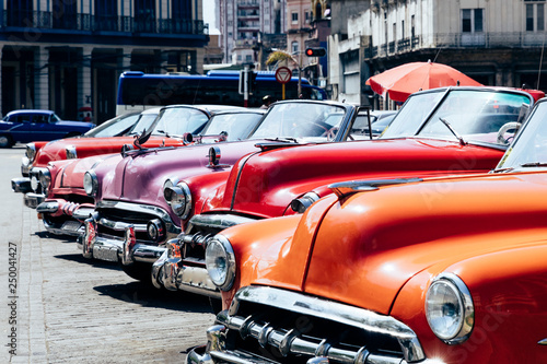 Vintage american cars parked on the street near Central Park in downtown Havana,