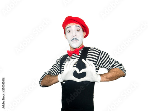 Man in striped sweater, white gloves showing love sign by hands. Clown, artist , mime.Isolated on white background