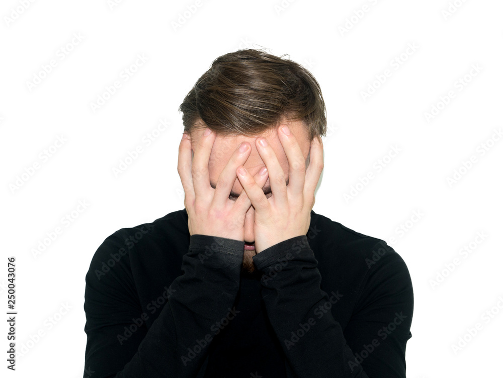 Portrait of despair young man closed face by two hands. Isolated on a white background. Portrait of despair young man closed face by two hands. Isolated on a white background.