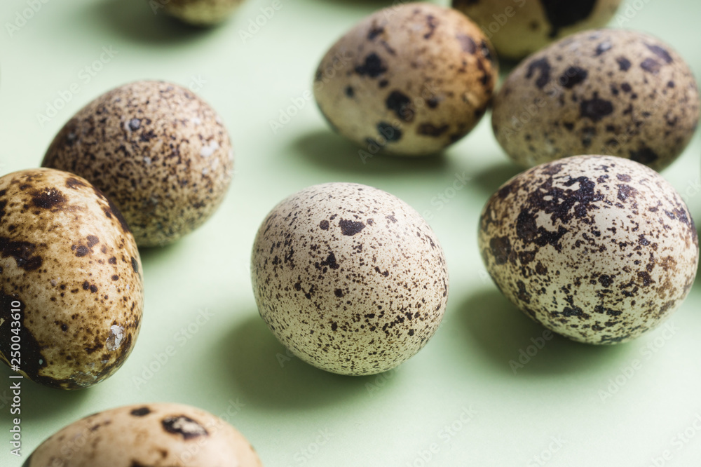 heap of quail eggs on color background. Vegetarian organic eco food. heap of quail eggs on color background. Vegetarian organic eco food.