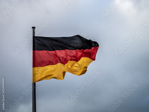 German national flag waving in the wind blue gray background  awesome contrast wave
