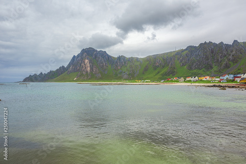 The village of Bleik squized between the mountains and the sea, seen from the harbor photo