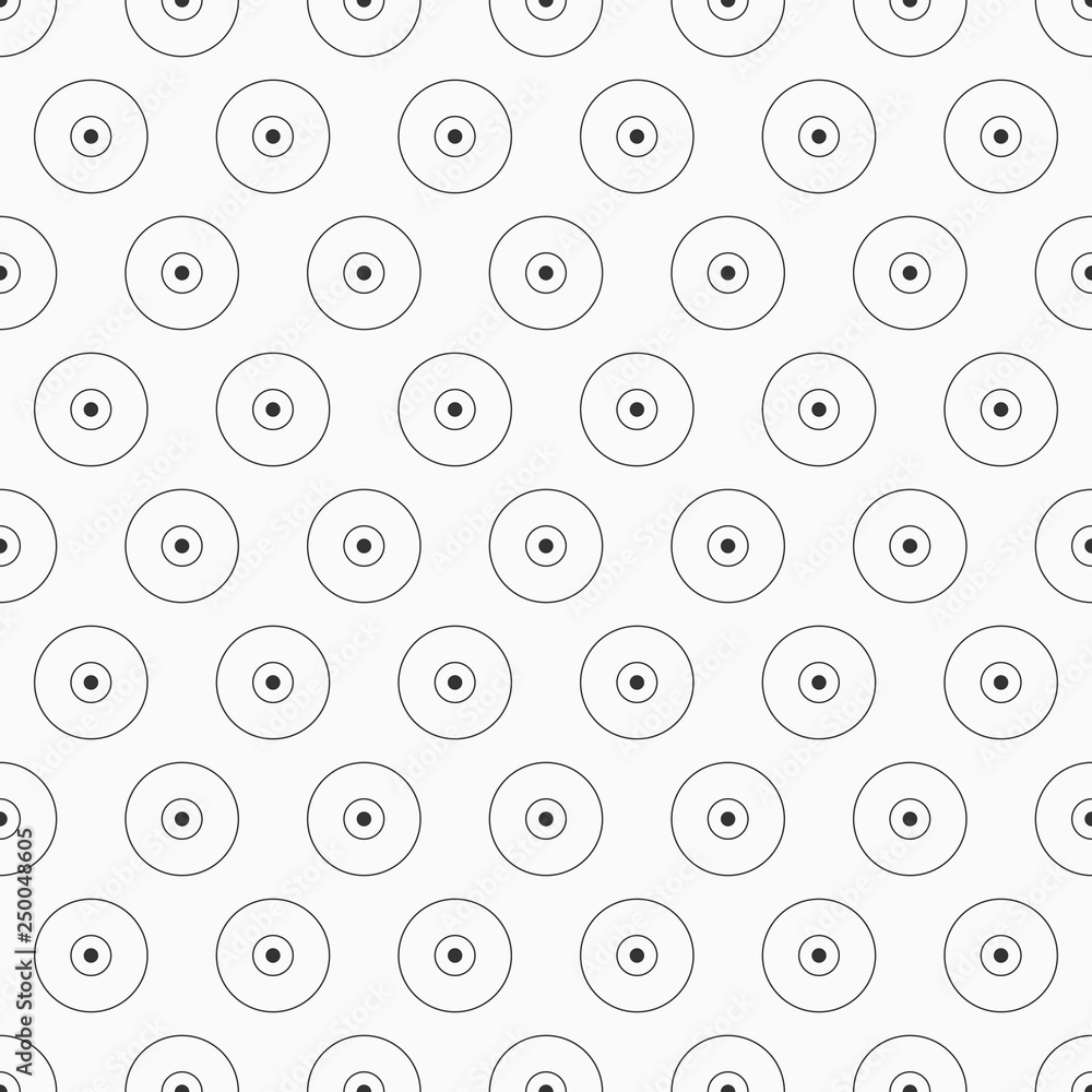 Abstract seamless pattern of regularly repeating circles and dots.
