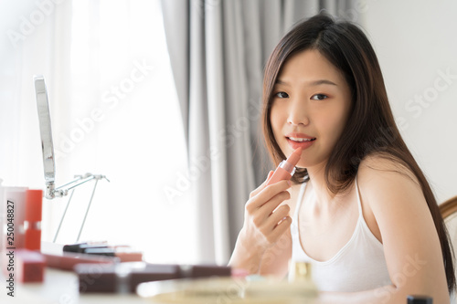 Young Asian female makeup beauty by lipstick