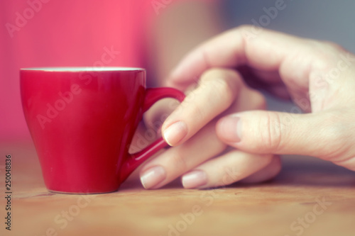 male hand touches female hand with a cup of coffee flirting, courting, love