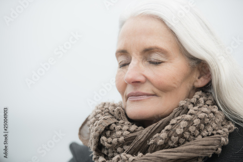 Canvas Print mature woman with grey hair dreaming