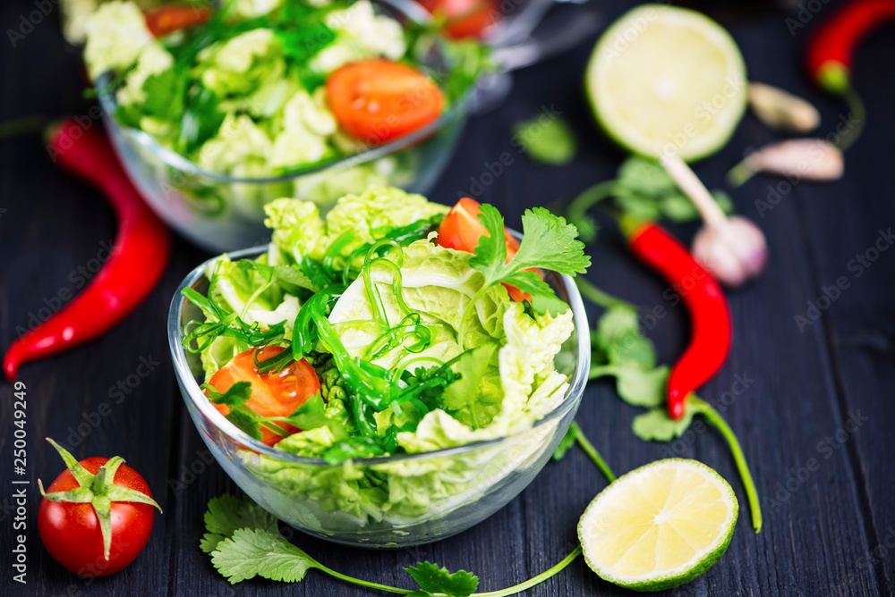 fresh vegetable and green seaweed salad in a glass plate fresh vegetable and green seaweed salad in a glass plate