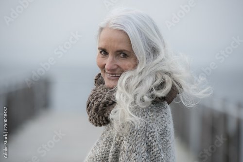 Принти на полотні portrait of a serene mature woman with long grey hair smiling