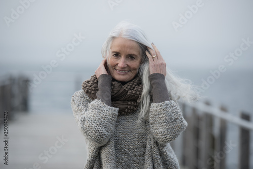 portrait of a serene mature woman with long grey hair 