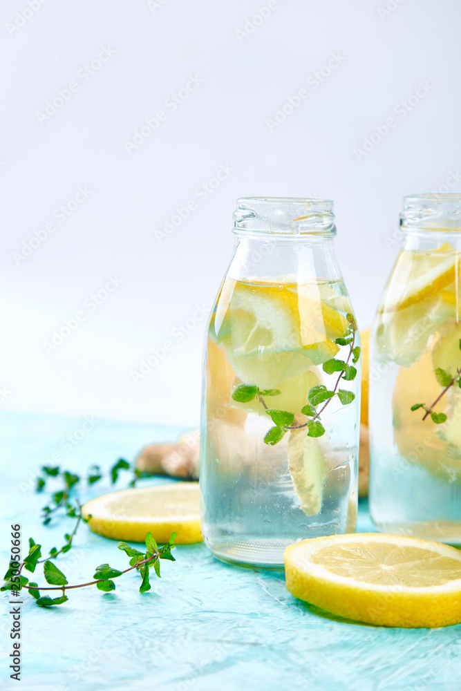 Detox water in bottles with ingredients, ginger, lemon, mint Detox water in bottles with ingredients, ginger, lemon, mint