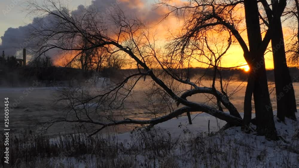 Breathtaking Sunrise between factory emissions and steaming river, time lapse. Breathtaking Sunrise between factory emissions and steaming river, time lapse.