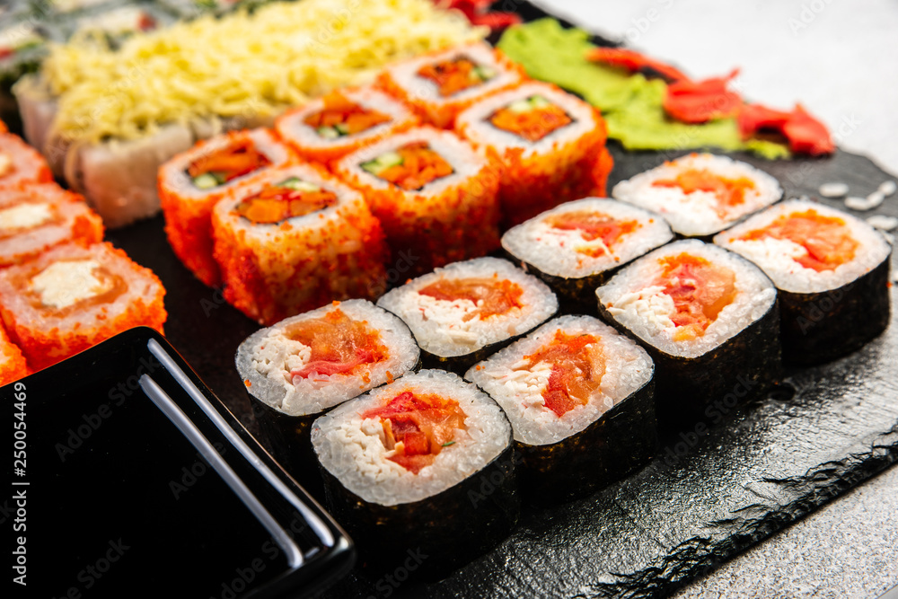 Big sushi set with variety of sushi rolls,on stylish dark background. Big sushi set with variety of sushi rolls,on stylish dark background.