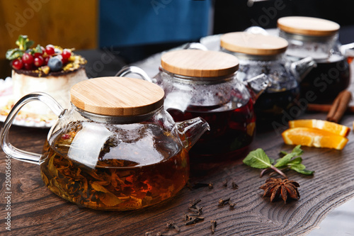 various teas in teapots on a wooden table. selective focus